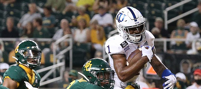 Kansas running back Pooka Williams Jr. (1) scores a touchdown past Baylor linebacker Terrel Bernard (2) in the second half of an NCAA college football game in Waco, Texas, Saturday, Sept. 26, 2020. (Jerry Larson/ Waco Tribune Herald/ pool)