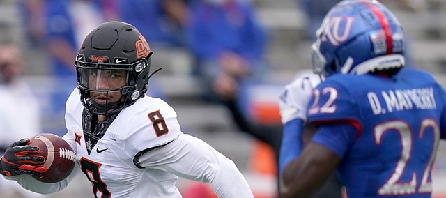Oklahoma State wide receiver Braydon Johnson (8) runs for a touchdown past Kansas cornerback Duece Mayberry (22) during the first half of an NCAA college football game in Lawrence, Kan., Saturday, Oct. 3, 2020. 