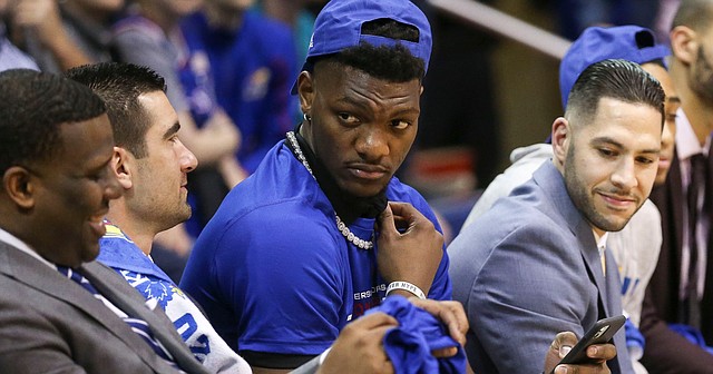 Kansas junior Silvio De Sousa shares a laugh with KU assistant coach Jerrance Howard (far left) as strength and conditioning coach Ramsey Nijem (right) looks on during KU's senior speeches on Wednesday, March 5, 2020 at Allen Fieldhouse.