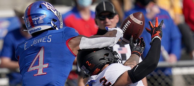 Kansas cornerback Elijah Jones (4) breaks up a pass intended for Oklahoma State wide receiver Tylan Wallace (2) during the first half of an NCAA college football game in Lawrence, Kan., Saturday, Oct. 3, 2020.