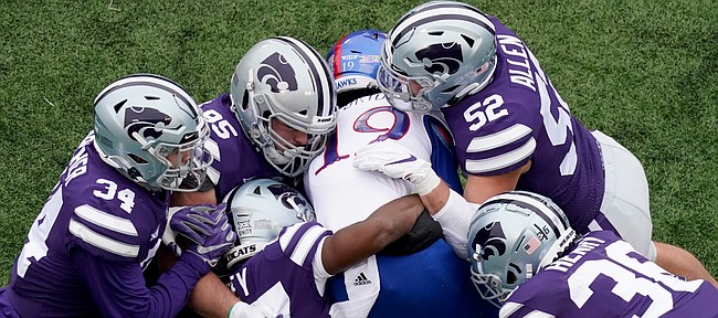Kansas wide receiver Steven McBride (19) is tackled by a group of Kansas State defenders during the second half of an NCAA football game Saturday, Oct. 24, 2020, in Manhattan, Kan. (AP Photo/Charlie Riedel)

