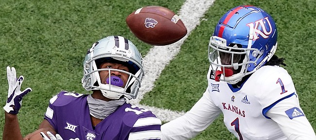 Kansas State wide receiver Chabastin Taylor (13) catches a long pass under pressure from Kansas safety Kenny Logan Jr. (1) during the second half of an NCAA college football game Saturday, Oct. 24, 2020, in Manhattan, Kan. Kansas State won 55-14. (AP Photo/Charlie Riedel)