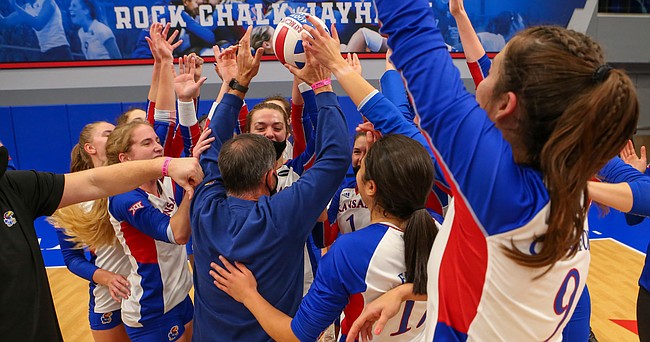The Kansas volleyball team mobs head coach Ray Bechard after a four-set victory over Kansas State on Thursday, Oct. 29, 2020, at Horejsi Family Volleyball Arena. The victory was the 400th of Bechard's KU career. 
