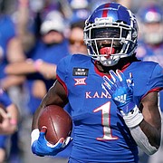 Kansas return specialist Kenny Logan Jr. (1) returns a kickoff 100-yards for a touchdown during the second half of an NCAA college football game against Iowa State in Lawrence, Kan., Saturday, Oct. 31, 2020. (AP Photo/Orlin Wagner)