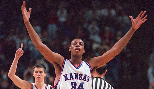 Former Jayhawks Paul Pierce and Ryan Robertson decked out in the home white of the 1990s. (File photo) 
