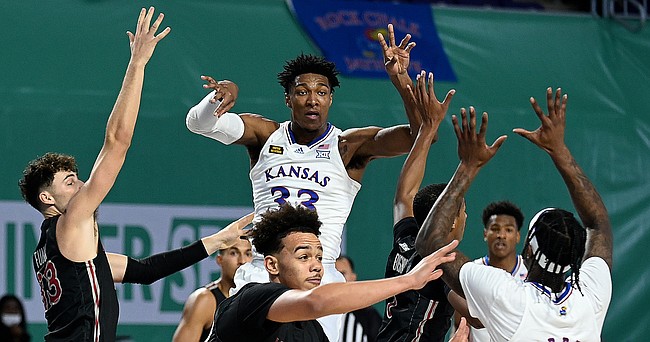 Kansas junior David McCormack throws a pass to senior Marcus Garrett during a game against Saint Joseph's on Friday Nov. 27, 2020. The Jayhawks earned a 94-72 win over the Hawks in the Rocket Mortgage Fort Myers Tip-Off at the Suncoast Credit Union Arena in Fort Myers, Florida.