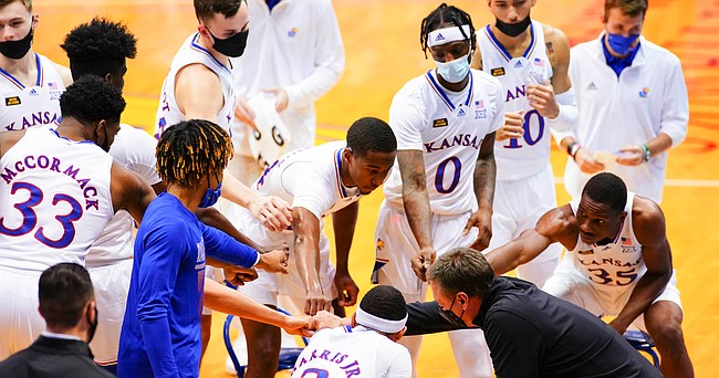 Kansas players come in for a fist bump after a timeout in the second half on Thursday, Dec. 3, 2020 at Allen Fieldhouse.