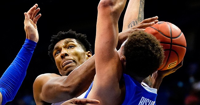 Kansas forward David McCormack (33) tangles for a ball with Creighton forward Christian Bishop (13) during the second half on Tuesday, Dec. 8, 2020 at Allen Fieldhouse.