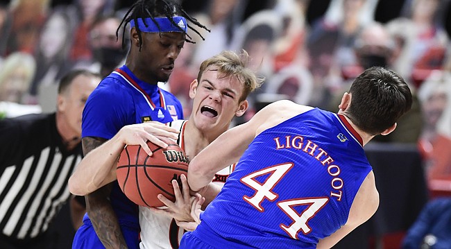 Kansas forward Mitch Lightfoot (44) strips the ball from Texas Tech's Mac McClung (0) during the first half of an NCAA college basketball game in Lubbock, Texas, Thursday, Dec. 17, 2020. (AP Photo/Justin Rex)
