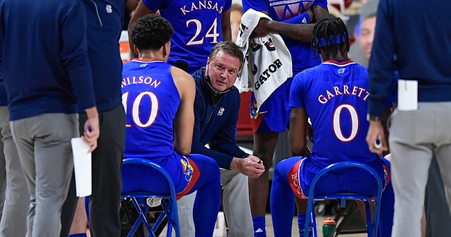 Kansas' head coach Bill Self talks to the team during in a timeout in the first half of an NCAA college basketball game against Texas Tech in Lubbock, Texas, Thursday, Dec. 17, 2020. 


