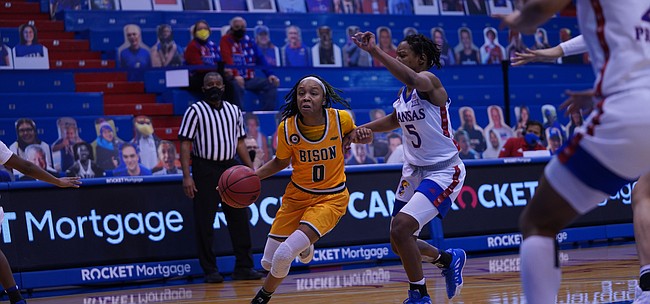 Kansas junior guard Aniya Thomas (5) guards a North Dakota State drive during Monday's game between KU and NDSU at Allen Fieldhouse on Dec. 21, 2020. The Jayhawks dropped a 72-69 decision to the Bison in their first game in 11 days.