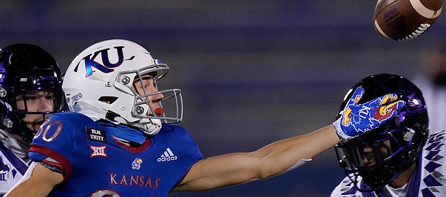 Kansas wide receiver Luke Grimm (80) reaches for the ball while covered by TCU linebacker Dee Winters (13) during the first half of an NCAA college football game in Lawrence, Kan., Saturday, Nov. 28, 2020. The pass was incomplete. (AP Photo/Orlin Wagner)