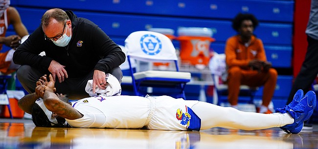 Kansas guard Marcus Garrett (0) lies on his back after suffering an elbow to the head during the second half, Saturday, Jan. 2, 2021 at Allen Fieldhouse.