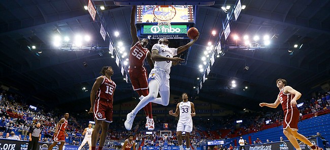 Kansas guard Marcus Garrett (0) floats in for a reverse layup against Oklahoma during the second half, Saturday, Jan. 9, 2021 at Allen Fieldhouse.