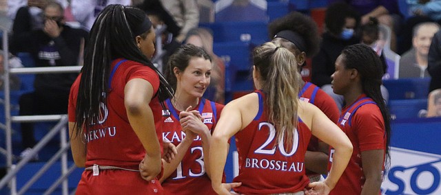 Members of the Kansas women's basketball team, including Holly Kersgieter (No. 13) and Julie Brosseau (No. 20) huddle up during the Jayhawks' home win over rival Kansas State on Jan. 23, 2021, at Allen Fieldhouse.