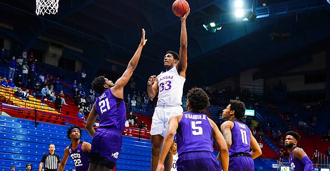 Kansas forward David McCormack (33) turns to put up a shot in the paint over TCU center Kevin Samuel (21) during the first half on Thursday, Jan. 28, 2021 at Allen Fieldhouse.