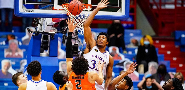 Kansas forward David McCormack (33) elevates to defend against a shot from Oklahoma State guard Cade Cunningham (2) during the second half on Monday, Feb. 8, 2021 at Allen Fieldhouse.