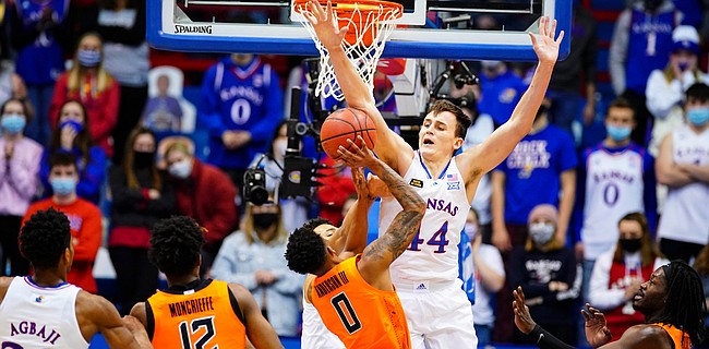 Kansas forward Mitch Lightfoot (44) gets up to block a shot from Oklahoma State guard Avery Anderson III (0) during the first half on Monday, Feb. 8, 2021 at Allen Fieldhouse.