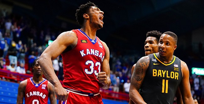 Kansas forward David McCormack (33) roars after swatting a Baylor shot late in the second half on Saturday, Feb. 27, 2021 at Allen Fieldhouse. At right is Baylor guard Mark Vital (11).