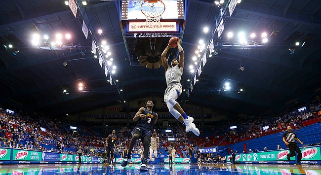 Kansas guard Ochai Agbaji (30) soars in for a breakaway dunk against UTEP guard Keonte Kennedy (3) during the second half on Thursday, March 4, 2021 at Allen Fieldhouse.