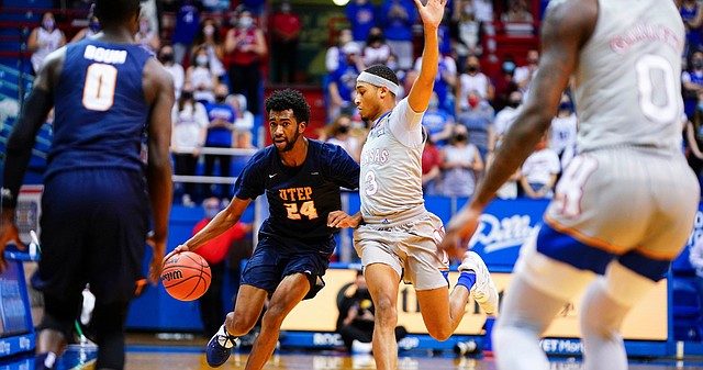 Kansas guard Dajuan Harris (3) pressures UTEP guard Jamal Bieniemy (24) as he drives the ball up the court during the first half on Thursday, March 4, 2021 at Allen Fieldhouse.