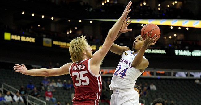 Kansas freshman guard Bryce Thompson goes in for a shot attempt versus Oklahoma's Brady Manek during the Phillips 66 Big 12 Basketball Championship at the T-Mobile Center in Kansas City, Missouri on March 10, 2021.