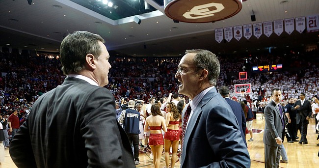 Kansas coach Bill Self and Oklahoma coach Lon Kruger meet on the court after the Sooners began celebrating after a last-second basket by Sooner guard Buddy Hield. The teams returned to the court because .2 seconds were still on the clock. The Jayhawks lost to the Sooners 75-73 Saturday in Norman.