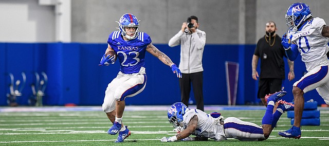 Kansas running back Amauri Pesek-Hickson looks to evade defenders during a spring practice at the Jayhawks' indoor facility in April of 2021.