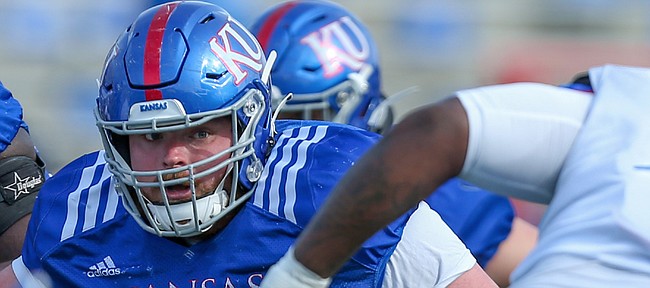 Kansas center Colin Grunhard looks in the direction of defensive lineman Caleb Sampson during the Jayhawks' practice on April 15, 2021.