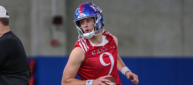 Kansas quarterback Conrad Hawley goes through a drill during one of the Jayhawks' spring practices at the team's indoor facility.