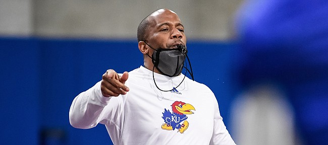 Kansas interim head football coach Emmett Jones leads players through a drill during a spring practice at the team's indoor facility. 