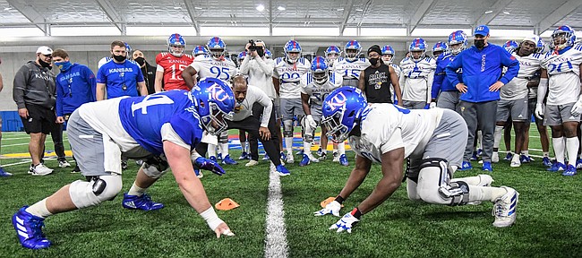 Kansas football players Colin Grunhard and Jereme Robinson square off during a drill at one of the Jayhawks 2021 spring practices.