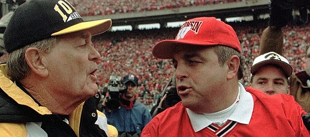 FILE - In this Nov. 8, 1997, file photo, Wisconsin coach Barry Alvarez, right, is congratulated by Iowa coach Hayden Fry after Wisconsin upset 12th ranked Iowa 13-10 in an NCAA college football game in Madison, Wis. (AP Photo/Morry Gash, File)


