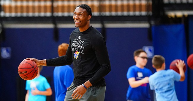 Kansas' David McCormack smiles as he watches campers work through drills at Washburn head coach Brett Ballard's basketball camp on Tuesday, June 15, 2021 at Lee Arena in Topeka.