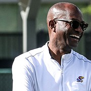 University of Kansas track and field coach Stanley Redwine lets out a laugh during a break at an event during the 2019 track season. 