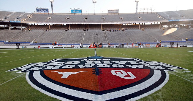 In this Oct. 10, 2020, file photo, The Red River Showdown logo is displayed on the field of the Cotton Bowl, prior to an NCAA college football game between the University of Texas and Oklahoma, in Dallas. Texas and Oklahoma made a request Tuesday, July 27, 2021, to join the Southeastern Conference — in 2025 —- with SEC Commissioner Greg Sankey saying the league would consider it in the “near future.”