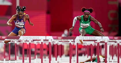 Christina Clemons of the United States and Tobi Amusan, right, of Nigeria, compete in a women's 100-meter hurdles semifinal at the 2020 Summer Olympics, Sunday, Aug. 1, 2021, in Tokyo.