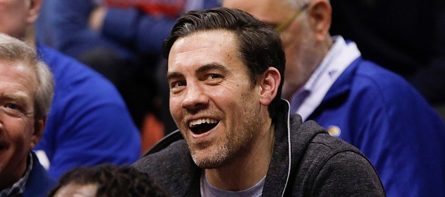 Jayhawk great and former Oklahoma City Thunder forward, Nick Collison smiles as he watches from behind the bench during the second half on Monday, Feb. 24, 2020 at Allen Fieldhouse.