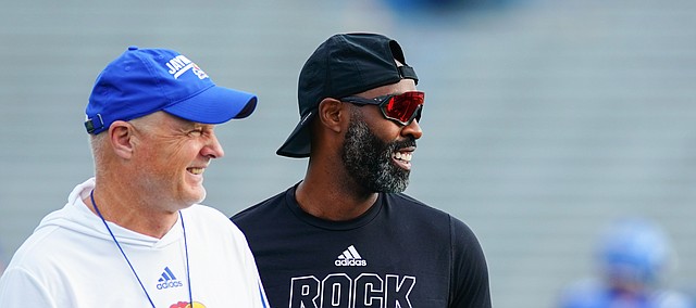 Kansas defensive coordinator Brian Borland, left, and cornerbacks coach Chevis Jackson have a laugh during practice on Saturday, Aug. 14, 2021 at Memorial Stadium.