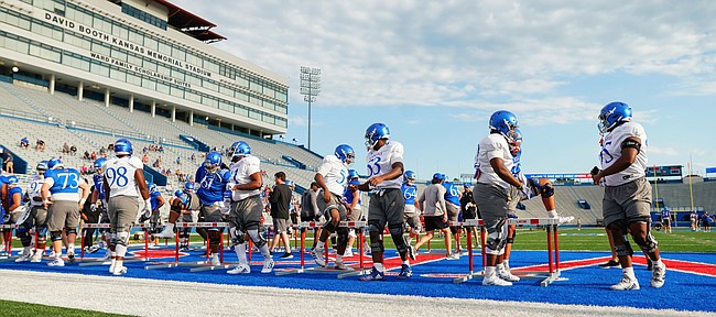 Kansas players get stretched out for practice on Saturday, Aug. 14, 2021 at Memorial Stadium.