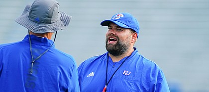 Kansas offensive coordinator Andy Kotelnicki talks with another member of the coaching staff during practice on Saturday, Aug. 14, 2021 at Memorial Stadium.