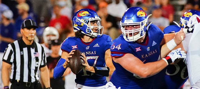 Kansas quarterback Jason Bean (17) drops back to sling a touchdown pass to the end zone during the second quarter on Friday, Sept. 3, 2021 at Memorial Stadium. (Photo by Nick Krug/Special to the Journal-World)
