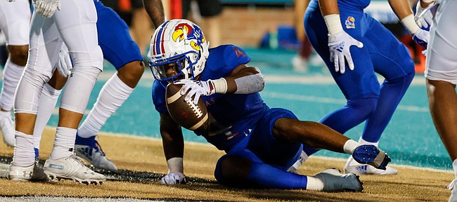 Kansas running back Devin Neal (4) gets up after scoring a touchdown against Coastal Carolina during the first half of an NCAA college football game in Conway, S.C., Friday, Sept. 10, 2021. (AP Photo/Nell Redmond)