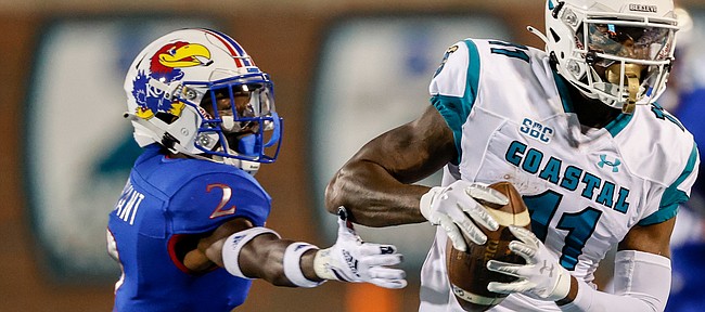 Coastal Carolina wide receiver Kameron Brown, right, catches a pass next to Kansas cornerback Jacobee Bryant during the first half of an NCAA college football game in Conway, S.C., Friday, Sept. 10, 2021. (AP Photo/Nell Redmond)