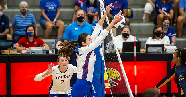 Middle blocker Caroline Crawford eats up a Kansas City Roos attack during the Jayhawks' four-set win on Thursday, Sept. 16, 2021 at Horejsi Family Volleyball Arena. 