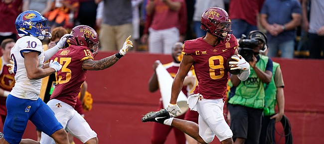 Iowa State wide receiver Xavier Hutchinson (8) scores on a 36-yard touchdown reception ahead of Kansas safety Jayson Gilliom (10) during the first half of an NCAA college football game, Saturday, Oct. 2, 2021, in Ames, Iowa. (AP Photo/Charlie Neibergall)