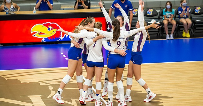 The Jayhawks celebrate a point during a recent home volleyball match at Horejsi Family Volleyball Arena. 