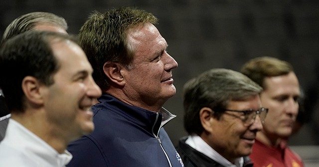 Big 12 mens basketball coaches from left, Scott Drew, Baylor, Bill Self, Kansas, Mark Adams, Texas Tech, and T.J. Otzelberger from Iowa State pose for a photo during Big 12 NCAA college basketball media day Wednesday, Oct. 20, 2021, in Kansas City, Mo. 