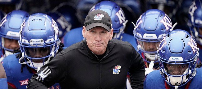 Kansas head coach Lance Leipold leads his team onto the field before an NCAA college football game against Oklahoma Saturday, Oct. 23, 2021, in Lawrence, Kan. (AP Photo/Charlie Riedel)