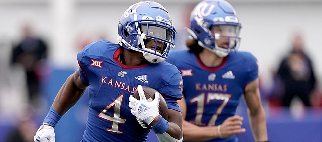 Kansas running back Devin Neal (4) runs the ball during the first half of an NCAA college football game against Oklahoma Saturday, Oct. 23, 2021, in Lawrence, Kan. (AP Photo/Charlie Riedel)